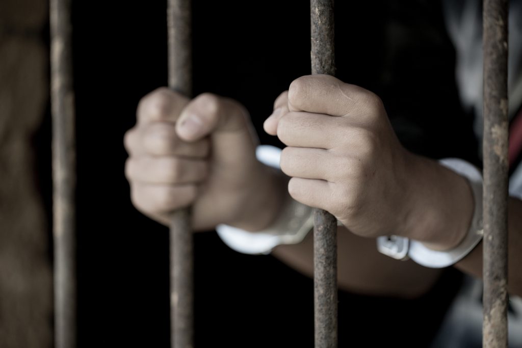 Forsyth County Bondsman bigstock Man In Prison Hands Of Behind 279494083